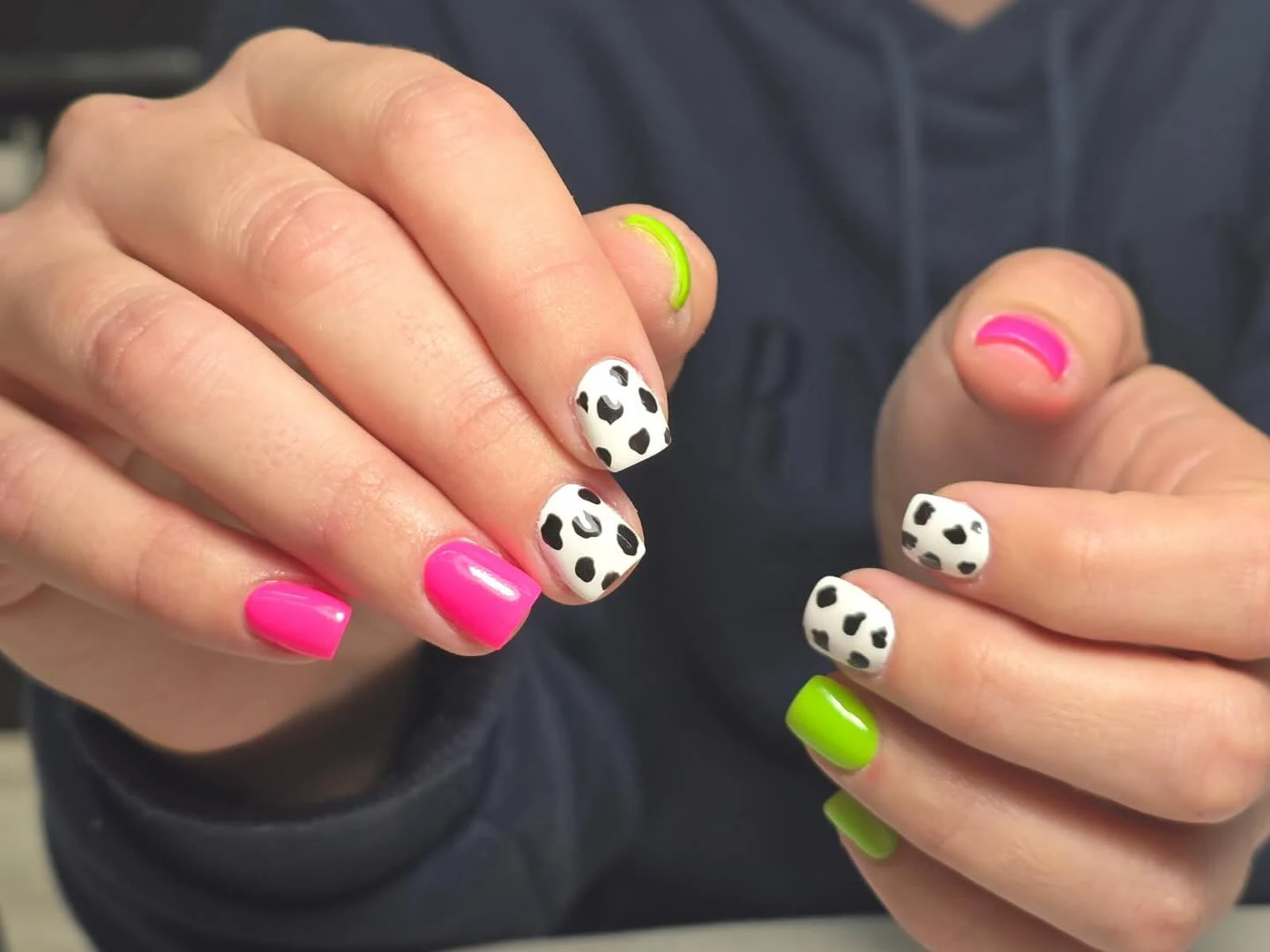 Hot-pink lime-green and cow-print short square nails