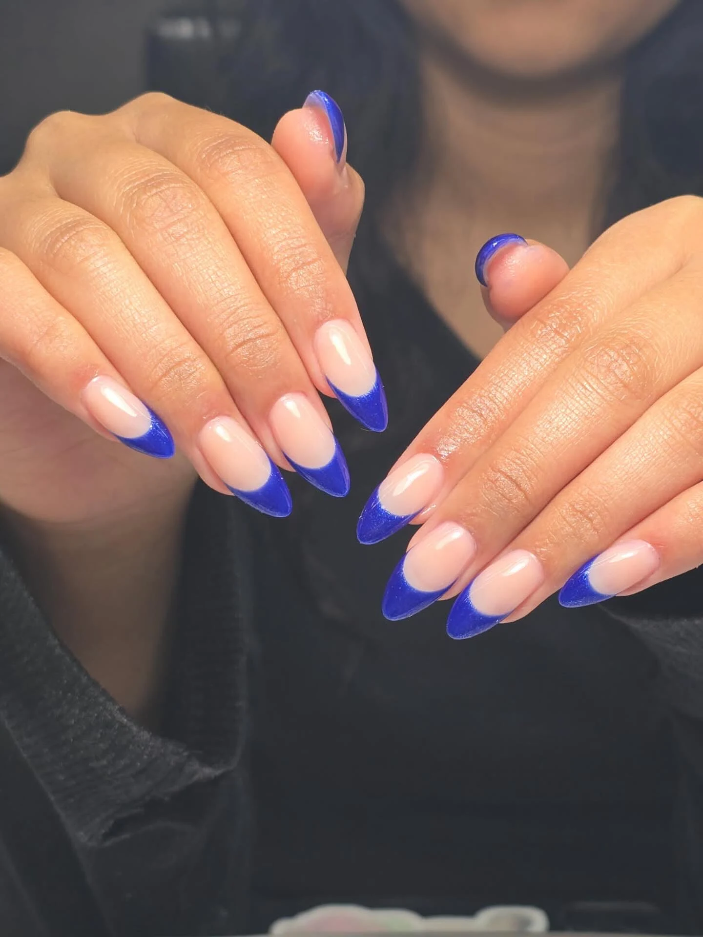 Cobalt-blue shimmer French tips on long almond nails