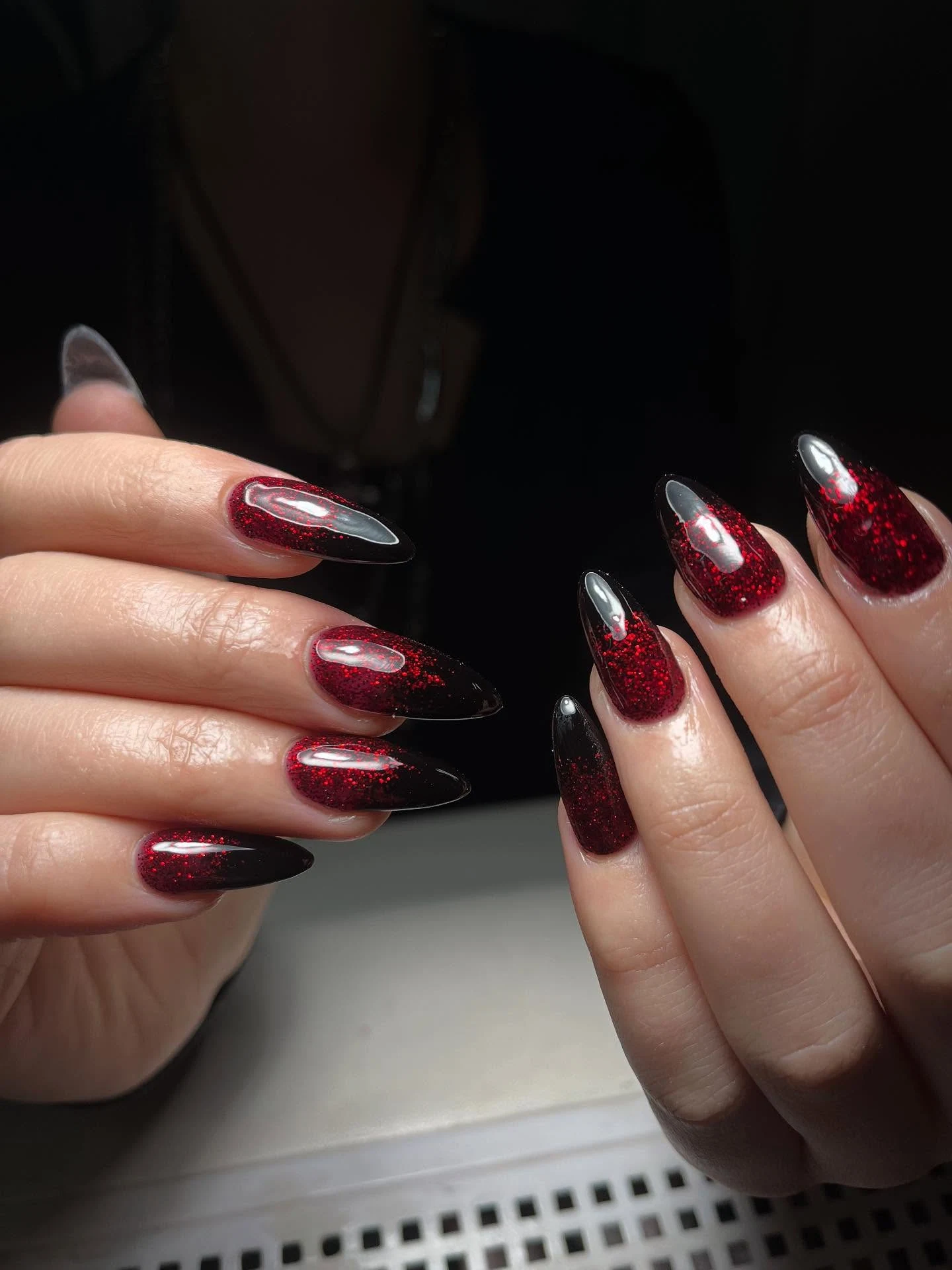 Black-to-red-glitter ombre long almond nails