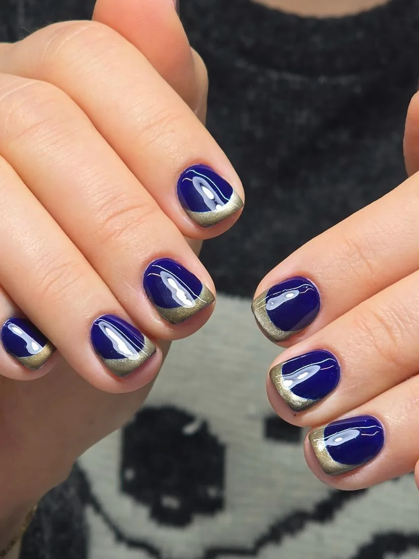 Deep navy square nails with metallic gold-pewter reverse-French tips